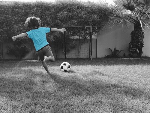 Child kicking soccer ball - project delivery